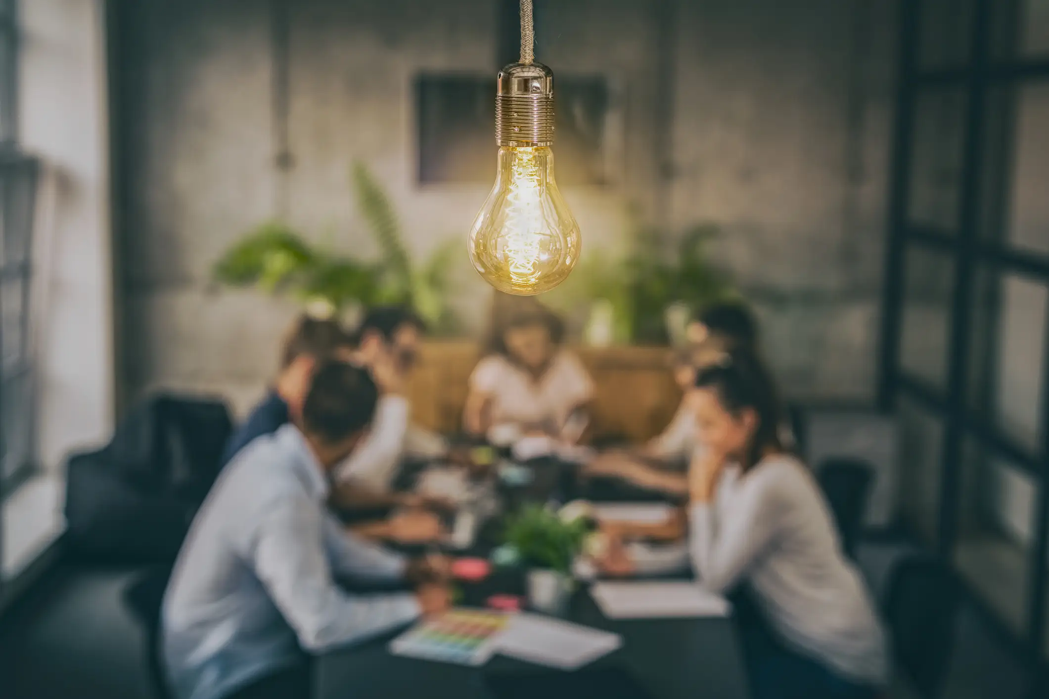 lightbulb and group of people at a table