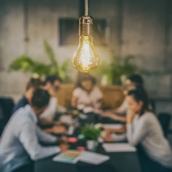 lightbulb and group of people at a table