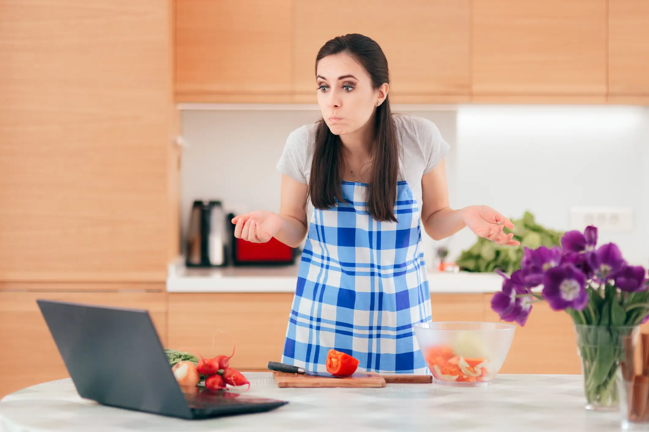 woman shrugging in a kitchen