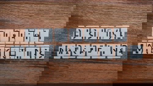 A collection of scrabble tiles spelling "digital marketing" in a post on digital marketing budget allocation.