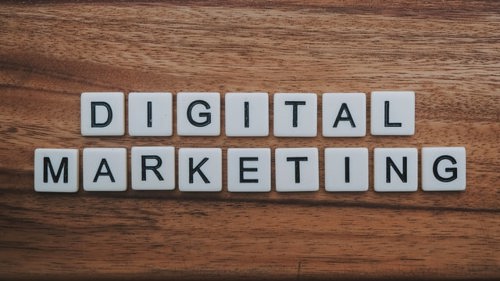 A collection of scrabble tiles spelling "digital marketing" in a post on digital marketing budget allocation.