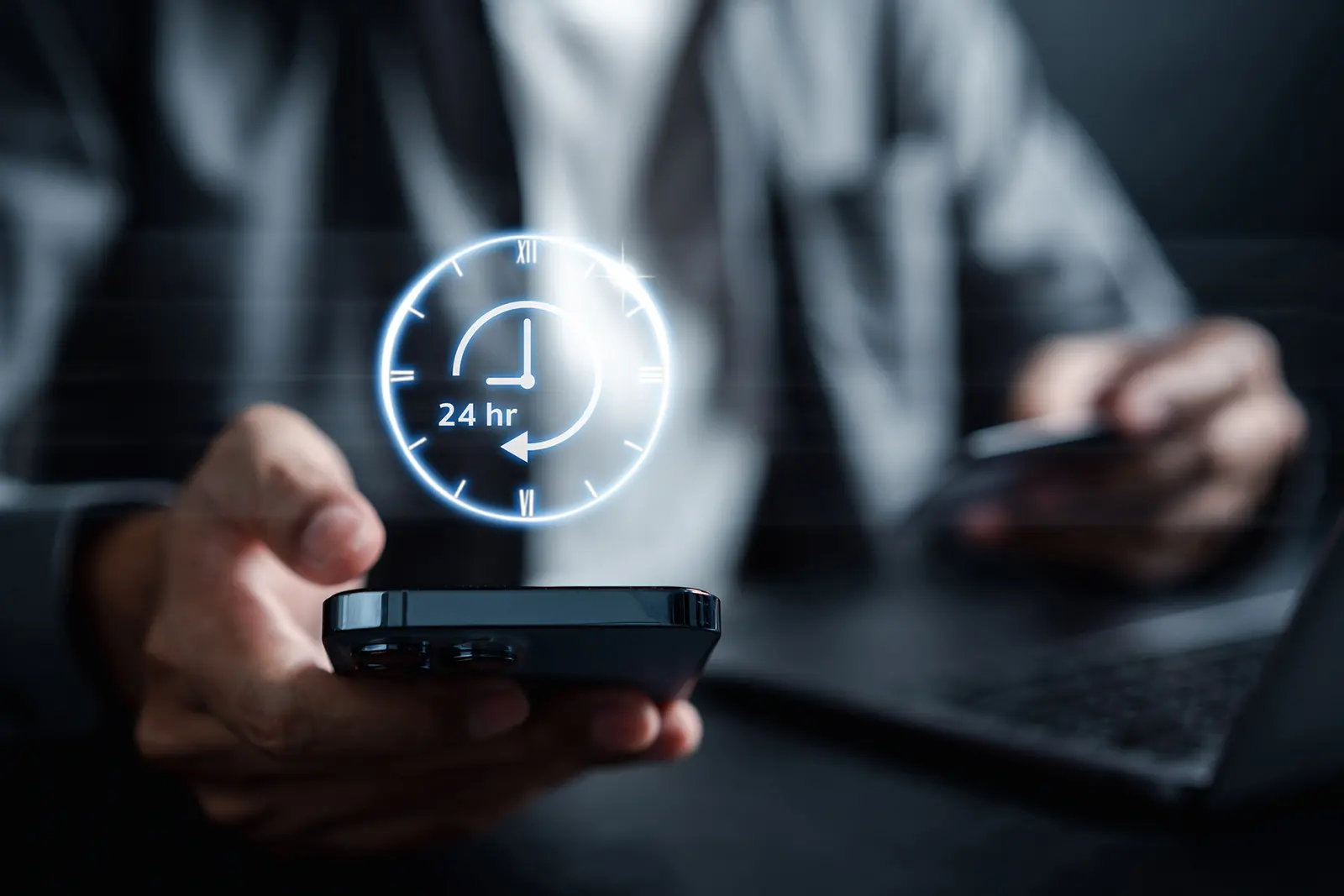 person holding phone with a 24hr time hologram above it
