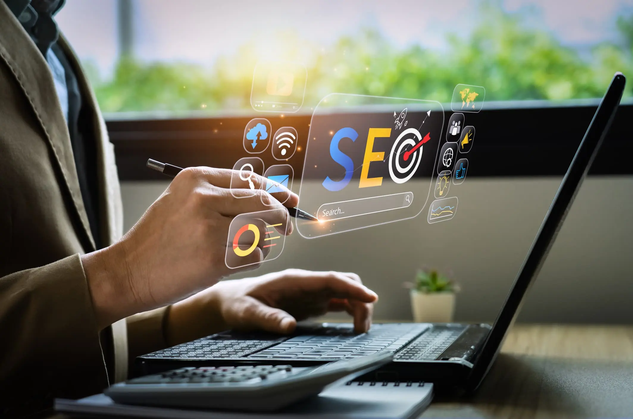 SEO graphics hovering over a laptop