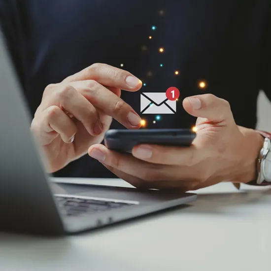 person holding phone with email icon
